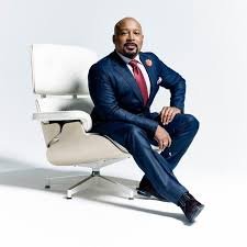 a man in a suit and tie sitting in a chair